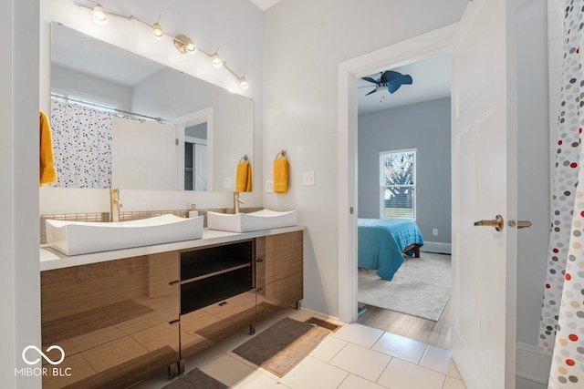 bathroom with tile patterned flooring, vanity, ceiling fan, and walk in shower