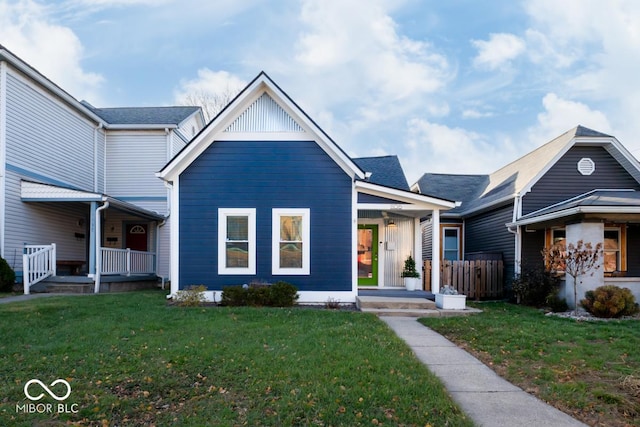 view of front of property with covered porch and a front yard