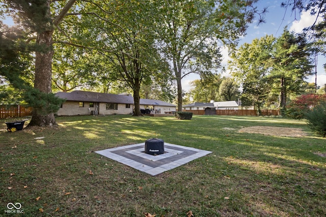 view of yard with a fire pit