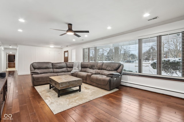 living room featuring wood-type flooring, crown molding, ceiling fan, and a baseboard heating unit