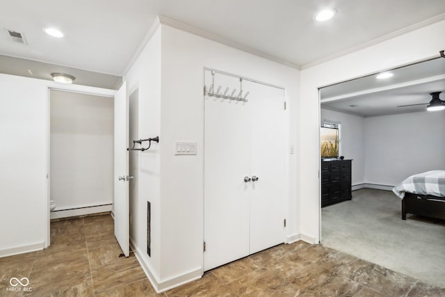 hallway with a baseboard radiator and crown molding