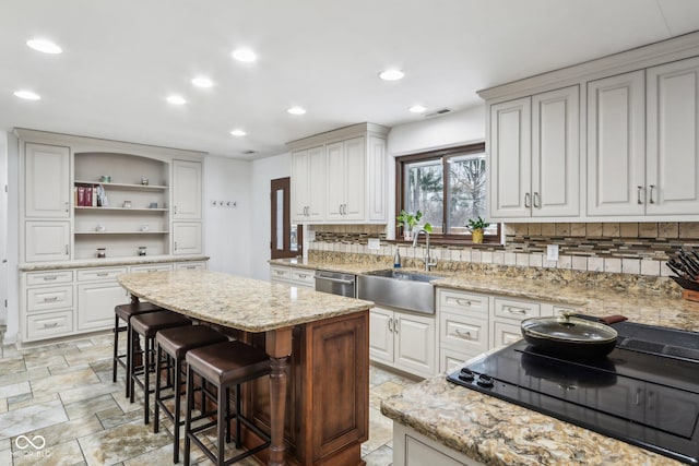 kitchen with white cabinets, decorative backsplash, and a kitchen island