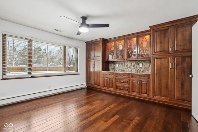 bar featuring backsplash, ceiling fan, dark hardwood / wood-style floors, and baseboard heating