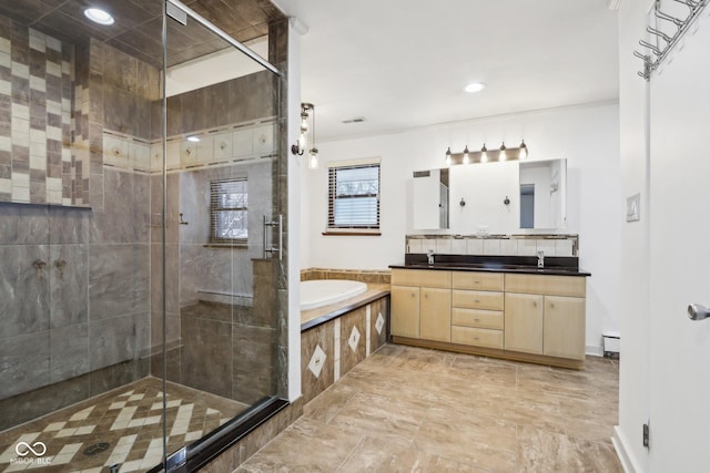 bathroom with vanity, baseboard heating, and independent shower and bath