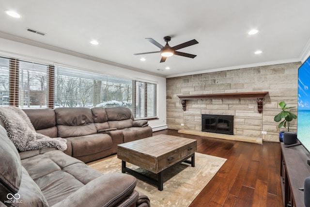 living room featuring a baseboard heating unit, ceiling fan, ornamental molding, a fireplace, and dark hardwood / wood-style flooring