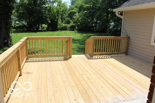 wooden deck with a lawn