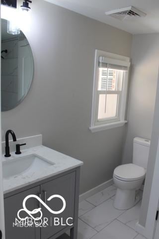 bathroom with vanity and toilet