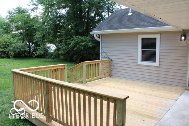 wooden terrace with a yard