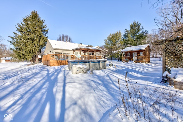 yard covered in snow with a pool side deck