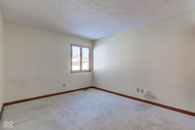 carpeted spare room with a textured ceiling