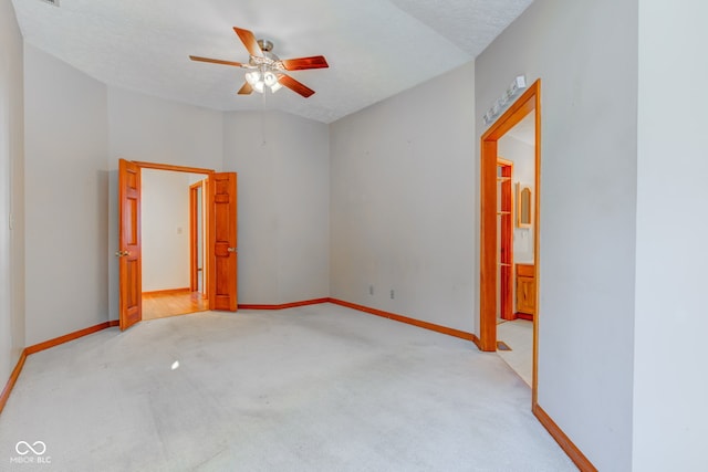 carpeted empty room featuring a textured ceiling and ceiling fan