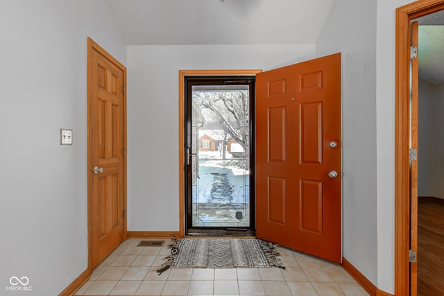 entryway featuring light tile patterned flooring