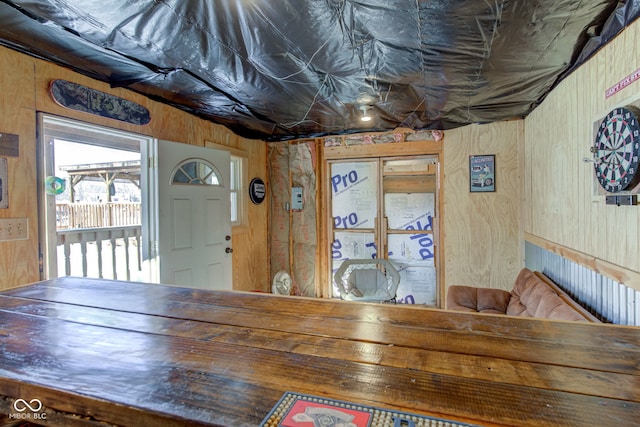 unfurnished dining area with wood walls