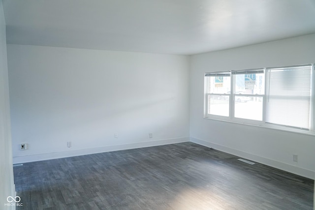 unfurnished room featuring dark hardwood / wood-style floors