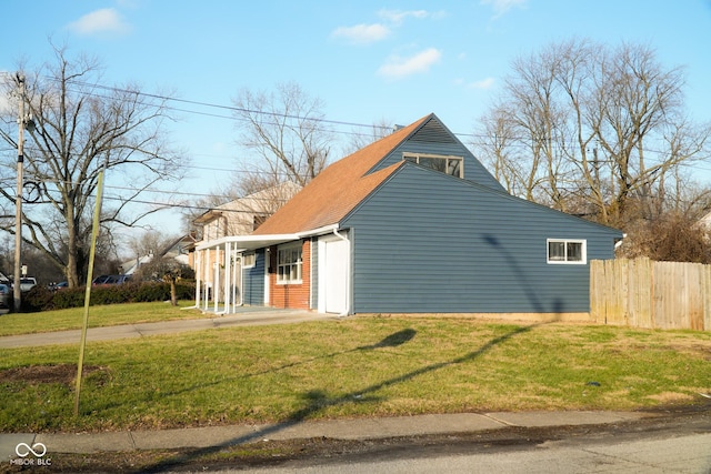 view of side of property with a lawn