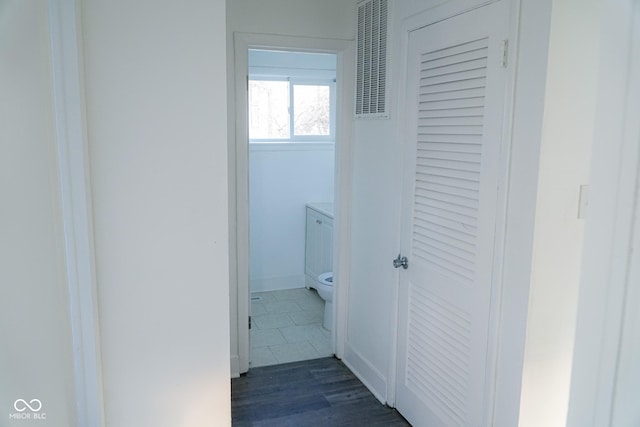 hallway with dark tile patterned floors