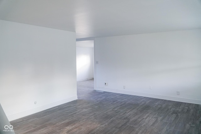 spare room with dark hardwood / wood-style floors