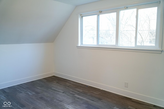 bonus room with dark hardwood / wood-style flooring and vaulted ceiling