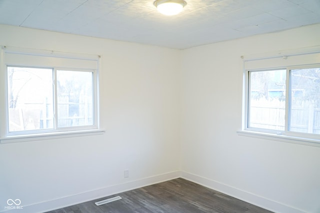 spare room with dark wood-type flooring