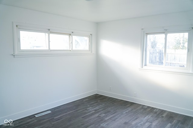 spare room with dark hardwood / wood-style floors