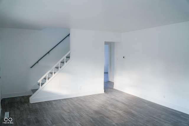 spare room with dark wood-type flooring