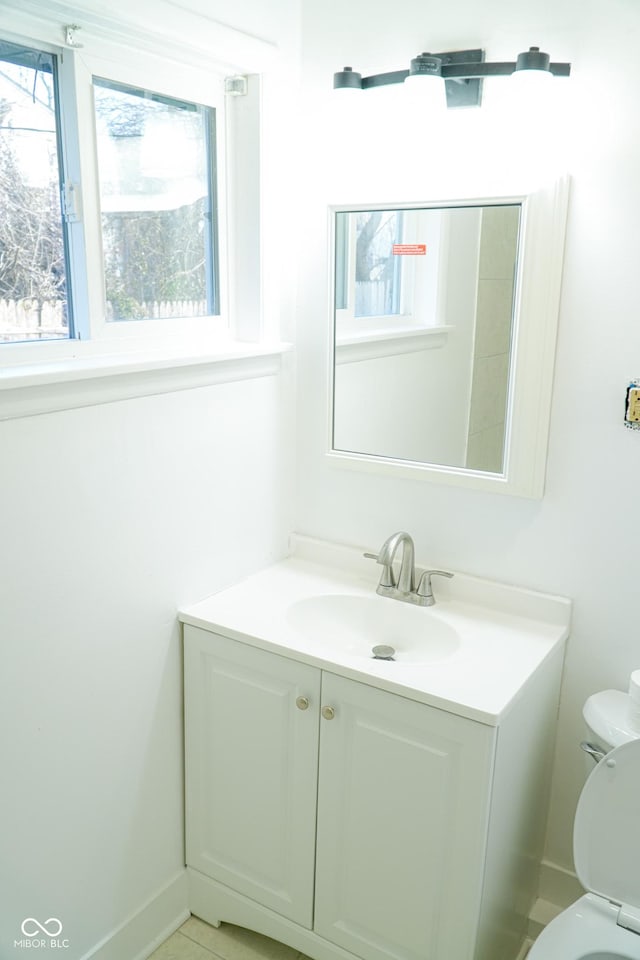 bathroom featuring vanity and toilet