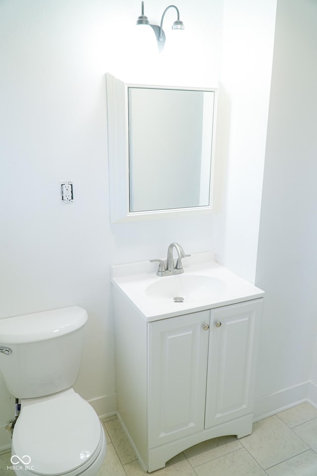 bathroom with tile patterned floors, vanity, and toilet