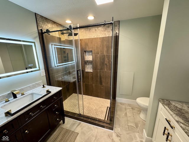 bathroom featuring a textured ceiling, vanity, toilet, and walk in shower