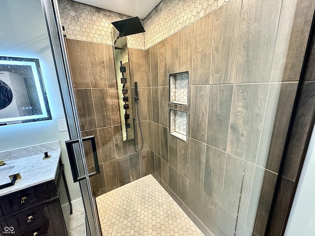 bathroom with vanity and tiled shower