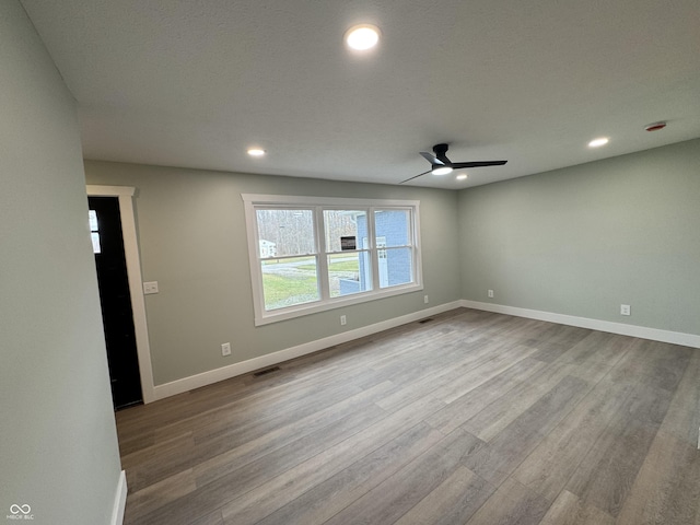 empty room featuring light wood-type flooring and ceiling fan