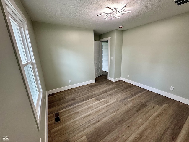 unfurnished bedroom with a textured ceiling and hardwood / wood-style flooring