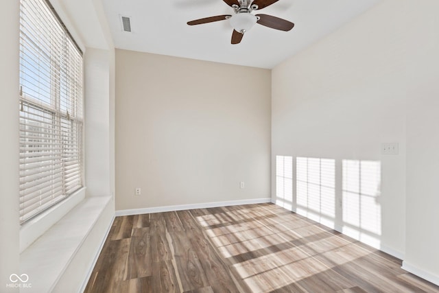 unfurnished room with ceiling fan, a healthy amount of sunlight, and wood-type flooring