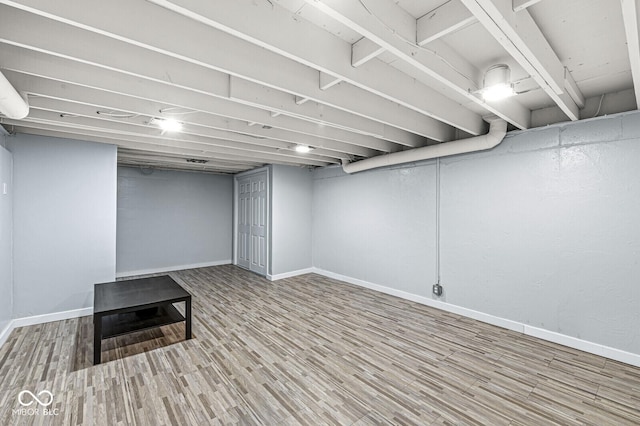 basement featuring hardwood / wood-style flooring