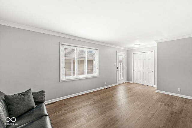 living room with hardwood / wood-style floors and ornamental molding