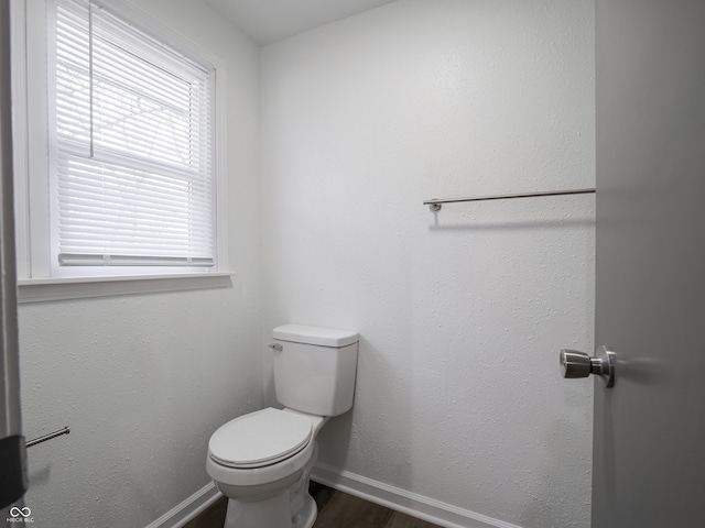 bathroom featuring hardwood / wood-style floors and toilet