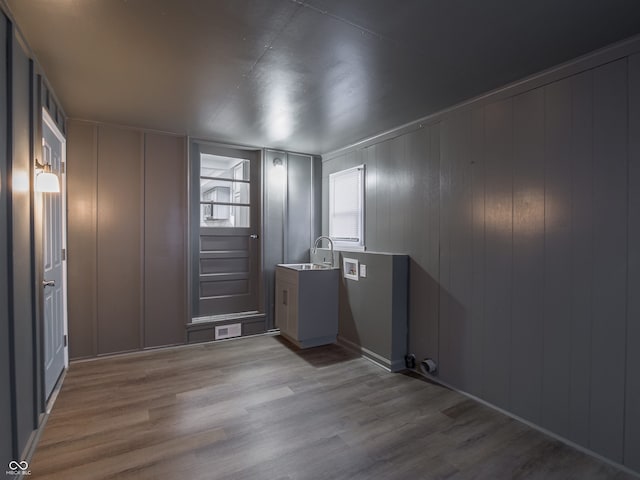 interior space with light hardwood / wood-style flooring and sink