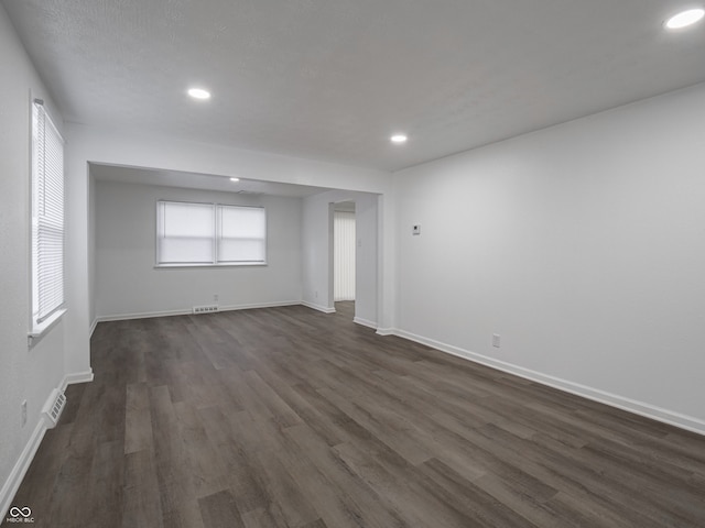 spare room with dark hardwood / wood-style flooring