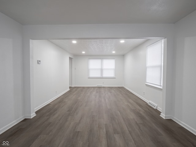 spare room with dark wood-type flooring