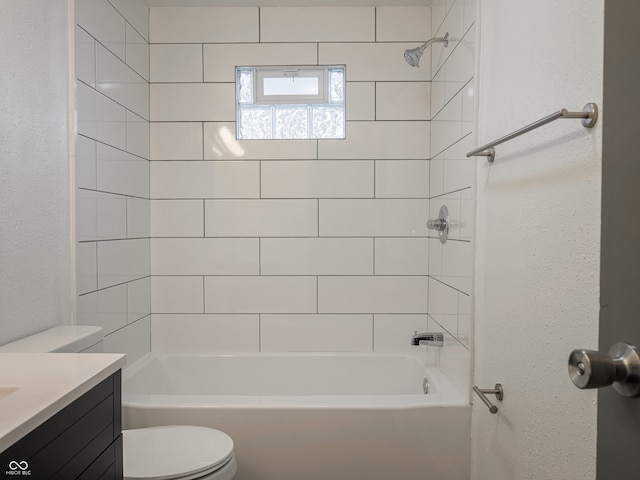 full bathroom featuring vanity, toilet, and tiled shower / bath