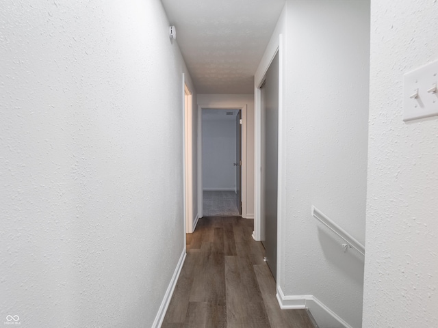 corridor featuring dark hardwood / wood-style flooring