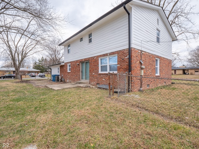 back of house with a patio area and a yard