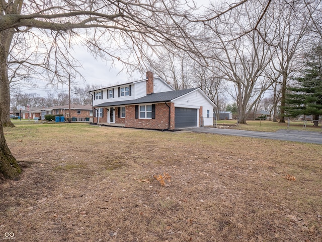 view of front of house with a front yard and a garage