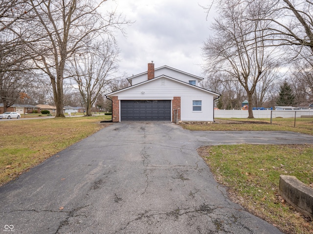 view of property exterior featuring a garage and a lawn