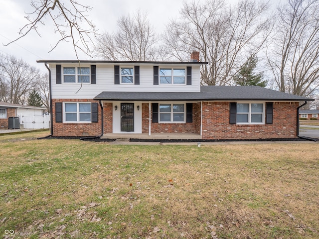 front facade with a front yard and central AC unit