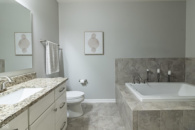 bathroom with tile patterned floors, vanity, tiled bath, and toilet