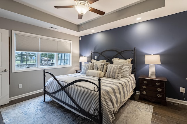 bedroom featuring ceiling fan and dark wood-type flooring