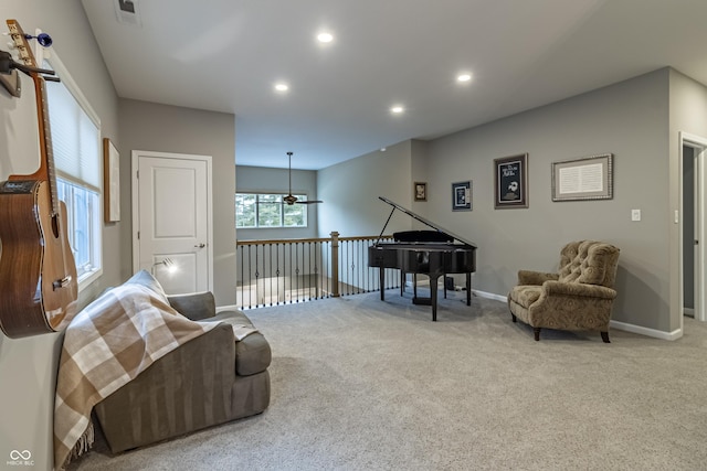 sitting room featuring ceiling fan and carpet