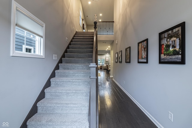 staircase with wood-type flooring