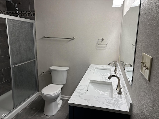 bathroom featuring an enclosed shower, vanity, toilet, and tile patterned floors