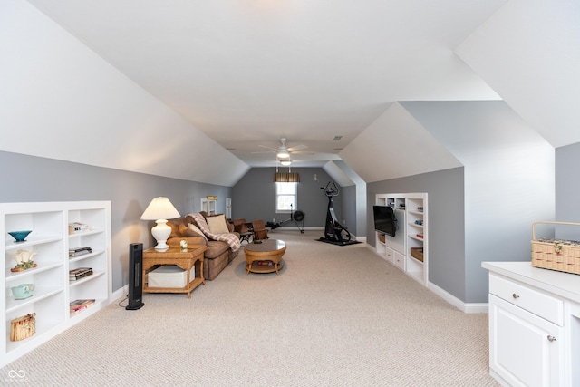 interior space with lofted ceiling, built in shelves, light colored carpet, and ceiling fan